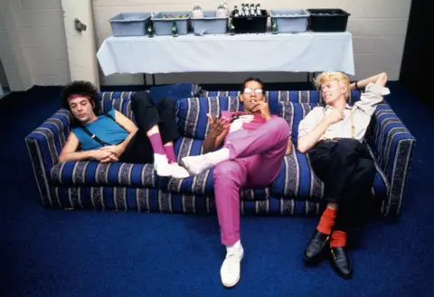 Denis O'Regan (l-r) Earl Slick, Carlos Alomar and David Bowie relax backstage