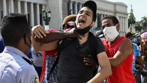 Getty Images A man is arrested during a demonstration against the government of Cuban President Miguel Diaz-Canel in Havana