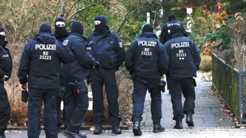 Getty Images German police outside a raided property in Germany, 7 December 2022