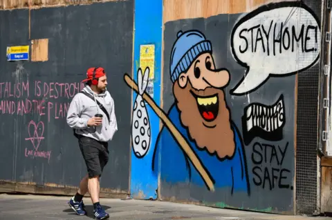 Getty Images Boarded up shops on Sauchiehall Street covered by graffiti