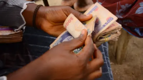 Getty Images A person counting Nigerian currency, July 2020