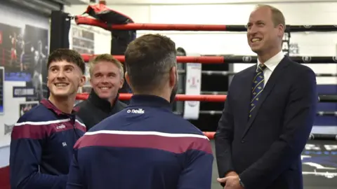 PA Media Prince William standing and talking with people from a boxing gym
