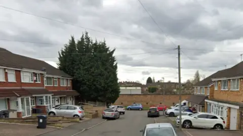 Cars are parked outside houses in the cul de sac and on side of the road.