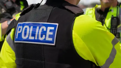 Generic image of the back of a police officer.