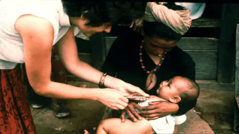 Britain Nepal Medical Trust Nurse Jan Patterson giving a BCG vaccination in Dhankuta