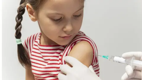 Getty Images Girl getting vaccinated