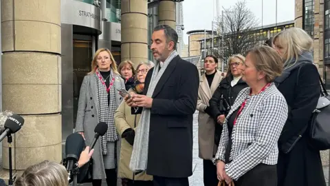 Lawyer Aamer Anwar and Covid Bereaved relatives at the opening of the UK Covid Inquiry hearings in Edinburgh