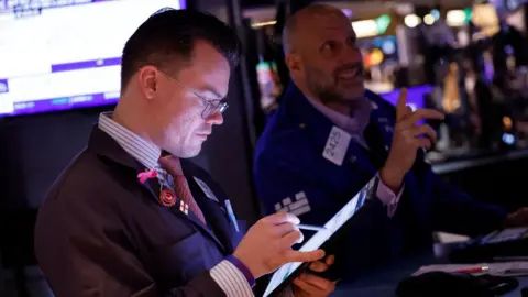 raders work on the floor of the New York Stock Exchange during morning trading on February 29, 2024 in New York City.