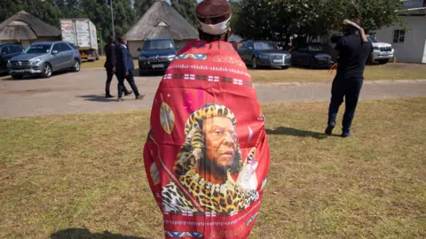 EPA A woman wearing a wrap with the image of Zulu King Goodwill Zwelithini in Nongoma, South Africa - 18 March 2021