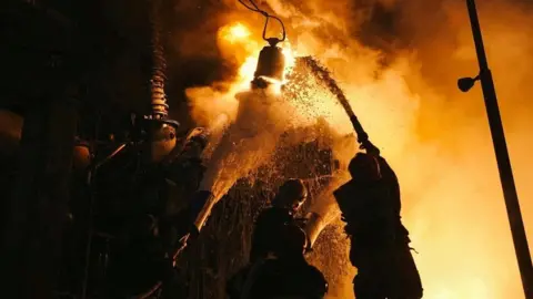 Reuters Ukrainian firefighters battle aftermath of Russian air strike