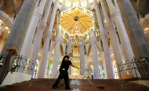 Reuters A man cleans the Sagrada Familia basilica ahead of its reopening, after being closed for over three months due to the coronavirus outbreak, Spain 3 July 2020
