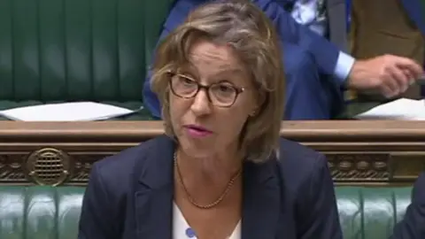 Women in blue jacket with glasses at dispatch box of House of Commons