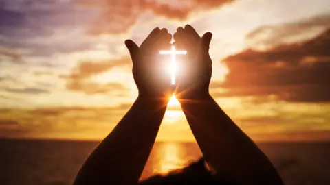 Getty Images Human hands open palm up worship.