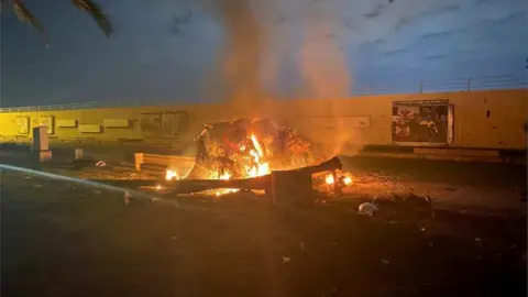 Reuters Burning debris outside Baghdad International Airport