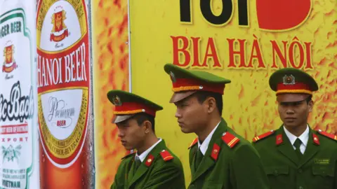HOANG DINH NAM/AFP/Getty Images Police at Hanoi beer festival, 2014