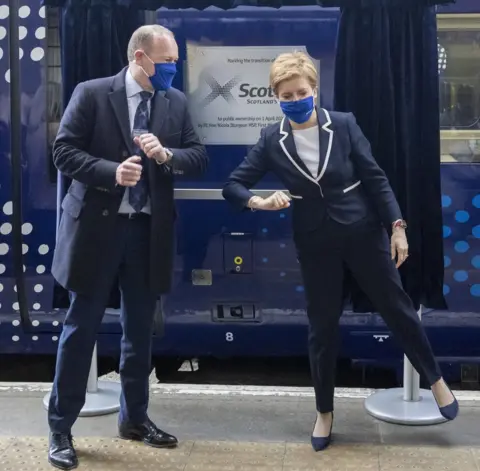 PA Media Nicola Sturgeon and Alex Hynes, Scotland’s Railway managing director