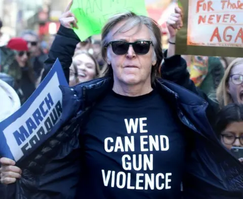 Getty Images McCartney at the gun control protest, sporting a 'We can end gun violence' t-shirt