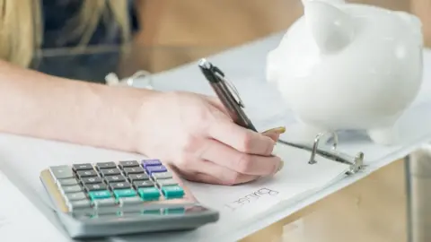 Getty Images Generic teenager calculating their budget