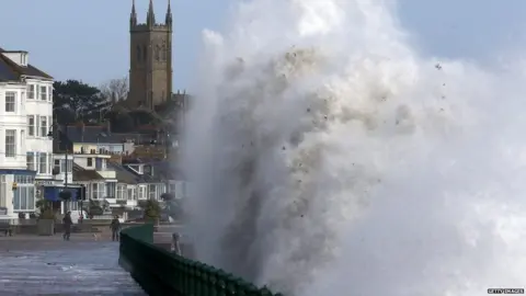 Getty Images Waves crash onto Penzance seafront in Cornwall