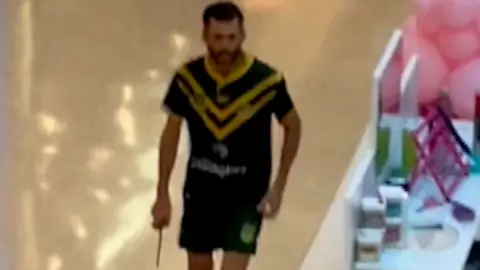 Rohan Anderson Joel Cauchi pictured holding a knife inside the shopping centre