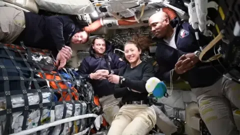 (From left) Jeremy Hansen, Reid Wiseman, Christina Koch and Victor Glover conduct a live broadcast from space
