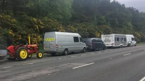 Kev Chambers Tractor on the road with vehicles in front of it
