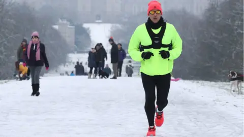 PA Wire A jogger braves at Windsor Castle, Berkshire