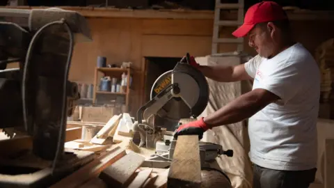 Megan Janetsky Eduardo Jiménez uses a saw in a carpentry project he created in Cajolá, Guatemala