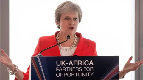 AFP Theresa May at a press conference in South Africa