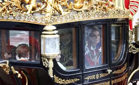 Reuters Prince and Princess of Wales and family in a carriage behind the Gold State Coach