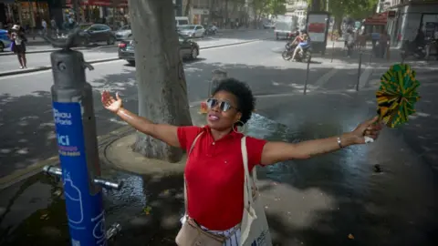 Getty Images Image shows woman cooling in heat