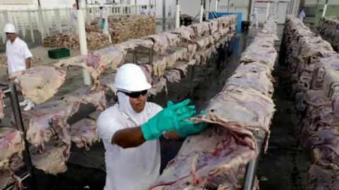 Reuters Worker at JBS processing plant in Santana de Parnaiba, Brazil, December 2017 file picture