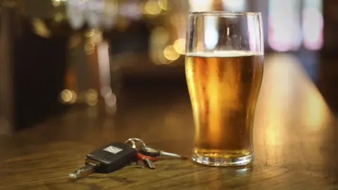 Press Association Pint glass on a table with car keys