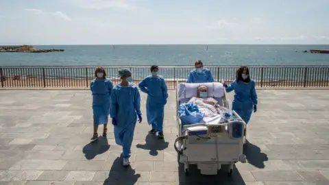 Getty Images Doctors in Barcelona take coronavirus patients to the beach