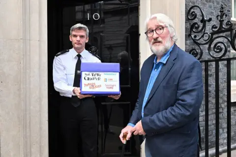 PA Media Jeremy Paxman presenting the Parky Charter at No 10