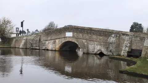 Robin Richardson Old stone bridge showing high water level in the river