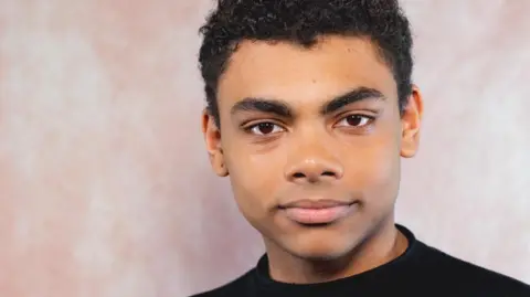 Celf Calon Young man looking at the camera with a neutral background