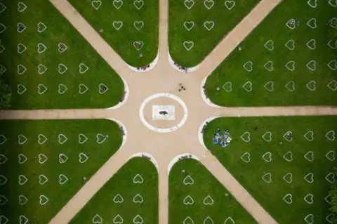 Matthew Horwood/Getty Images An aerial view of Queen Square where hearts have been sprayed onto the grass in an effort to encourage social distancing on 8 July 2020 in Bristol, England.