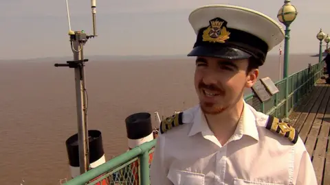 Purser Andrew Comrie in uniform with hat