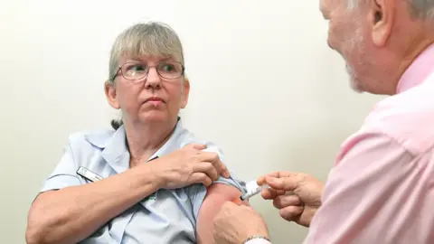 EPA A healthcare workers gets a jab in Brisbane