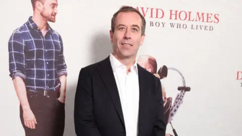 Getty Images Dan Hartley smiling at the premiere for the film