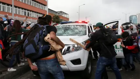 Reuters Demonstrators hit a police vehicle during a protest against the tax reform of President Ivan Duque"s government in Bogota, Colombia April 28, 2021.