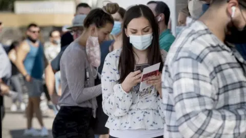 EPA Voters wait in a line of at least 200 people at a polling location in Scottsdale, Arizona