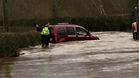 Cumbria Police Police at flooded Cliburn Hill near Penrith