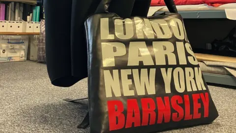 Rita Britton said the Pollyanna brand has released a large leather shopper which reads: 'London, Paris, New York, Barnsley'