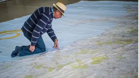 ALAMY Man on a giant Ordnance map