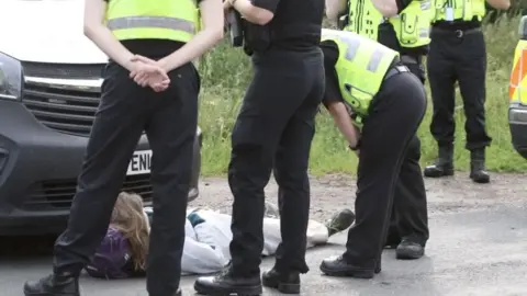 Freedom4animals A protester being spoken to by police at MBR Acres in Sawtry Way, Wyton
