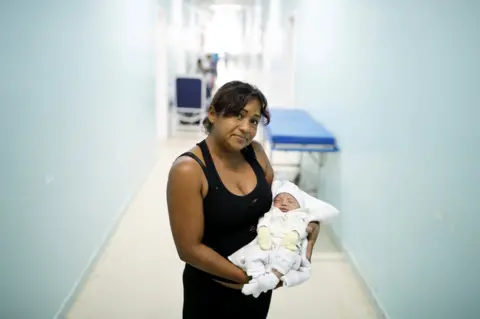 Nacho Doce/REUTERS Marisol, 44, a Venezuelan from Monagas state, holds her two-day-old baby Amalia at a maternity hospital in Boa Vista, Roraima state, Brazil, 21 August 2018