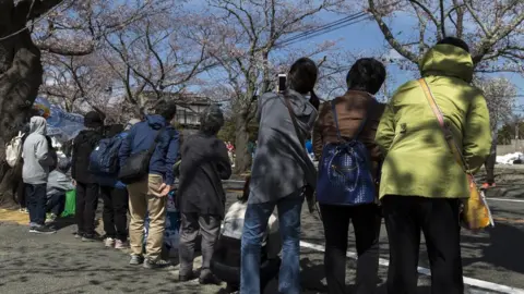 Getty Images Residents return to look at cherry blossom