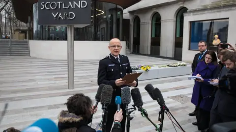 Getty Images Mark Rowley speaking to journalists outside New Scotland Yard in March last year.